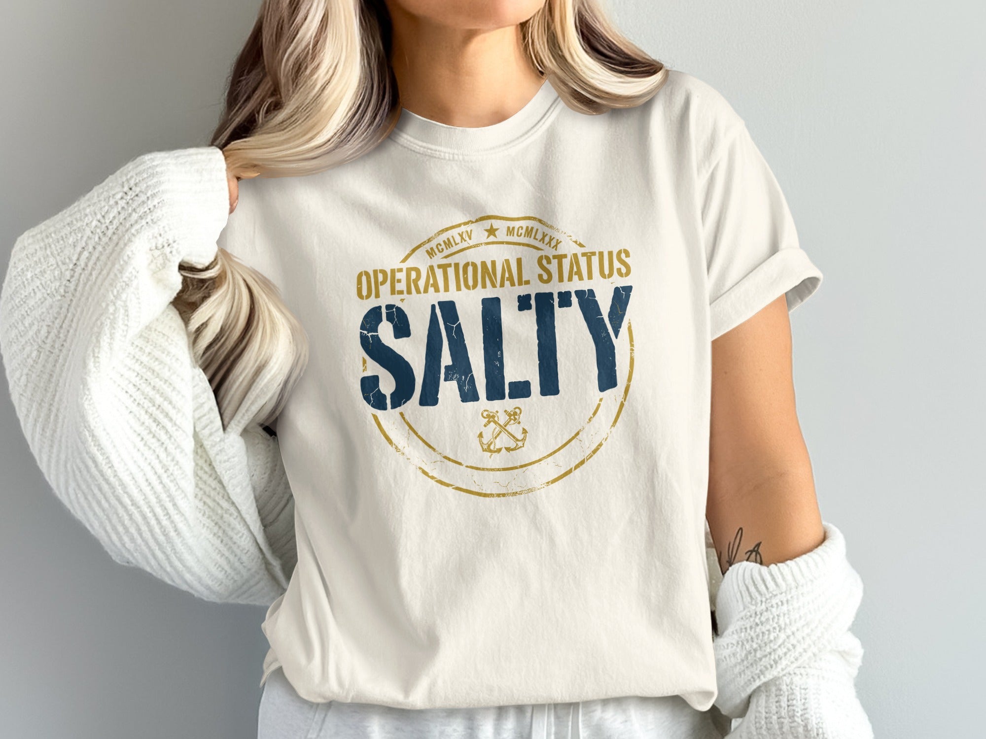 Cream t-shirt with "SALTY" in blue and gold nautical design.