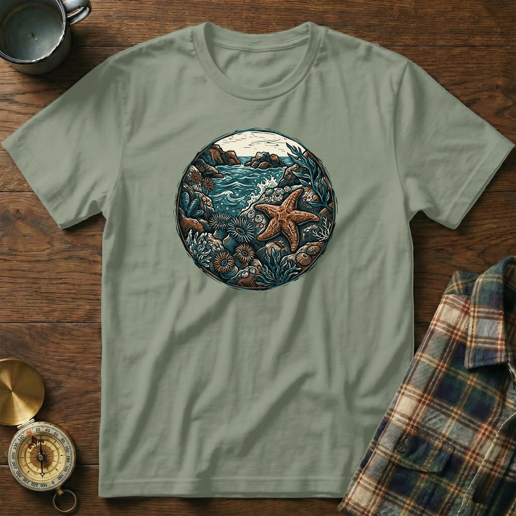 Green t-shirt with circular oceanic nature scene featuring starfish.