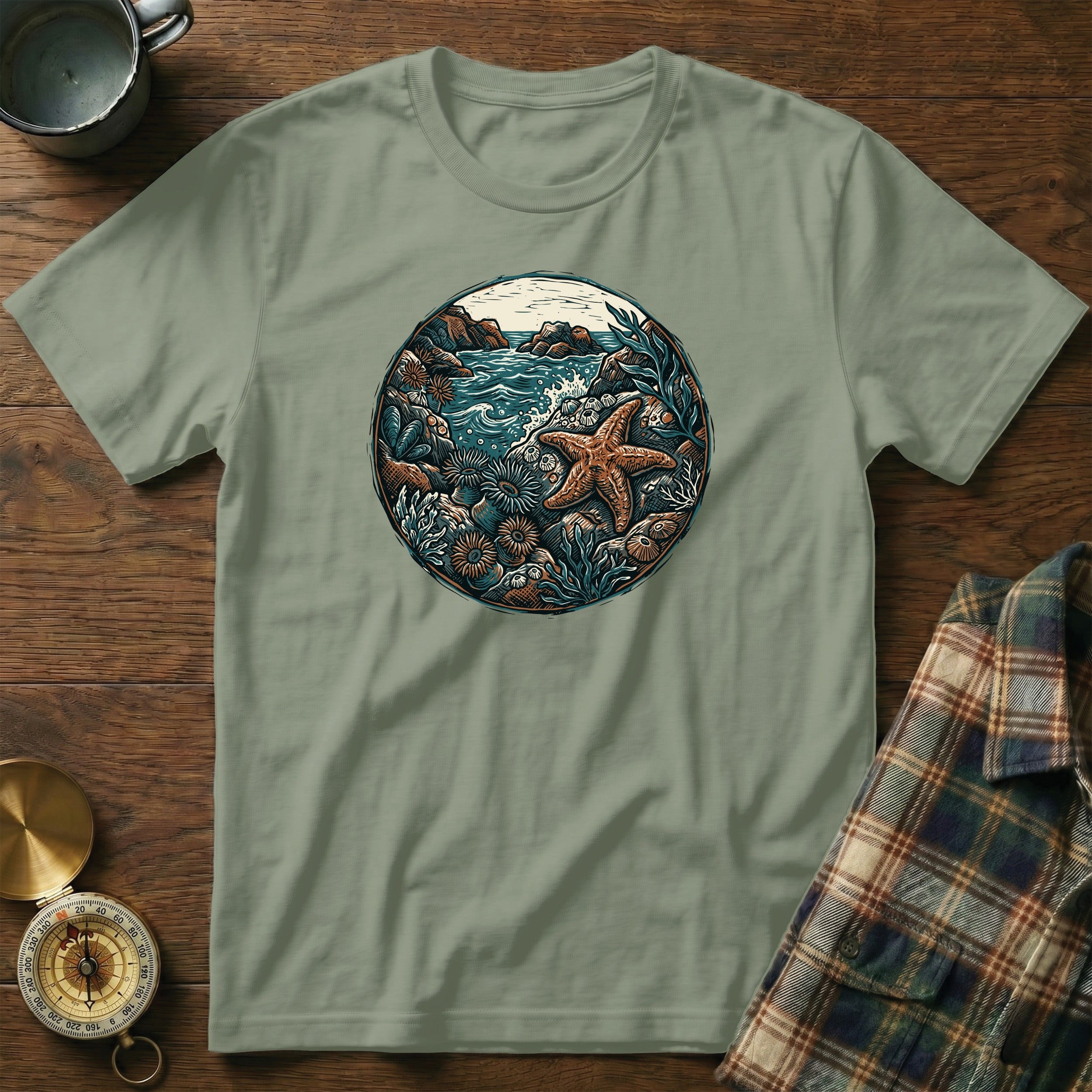 Green t-shirt with circular oceanic nature scene featuring starfish.