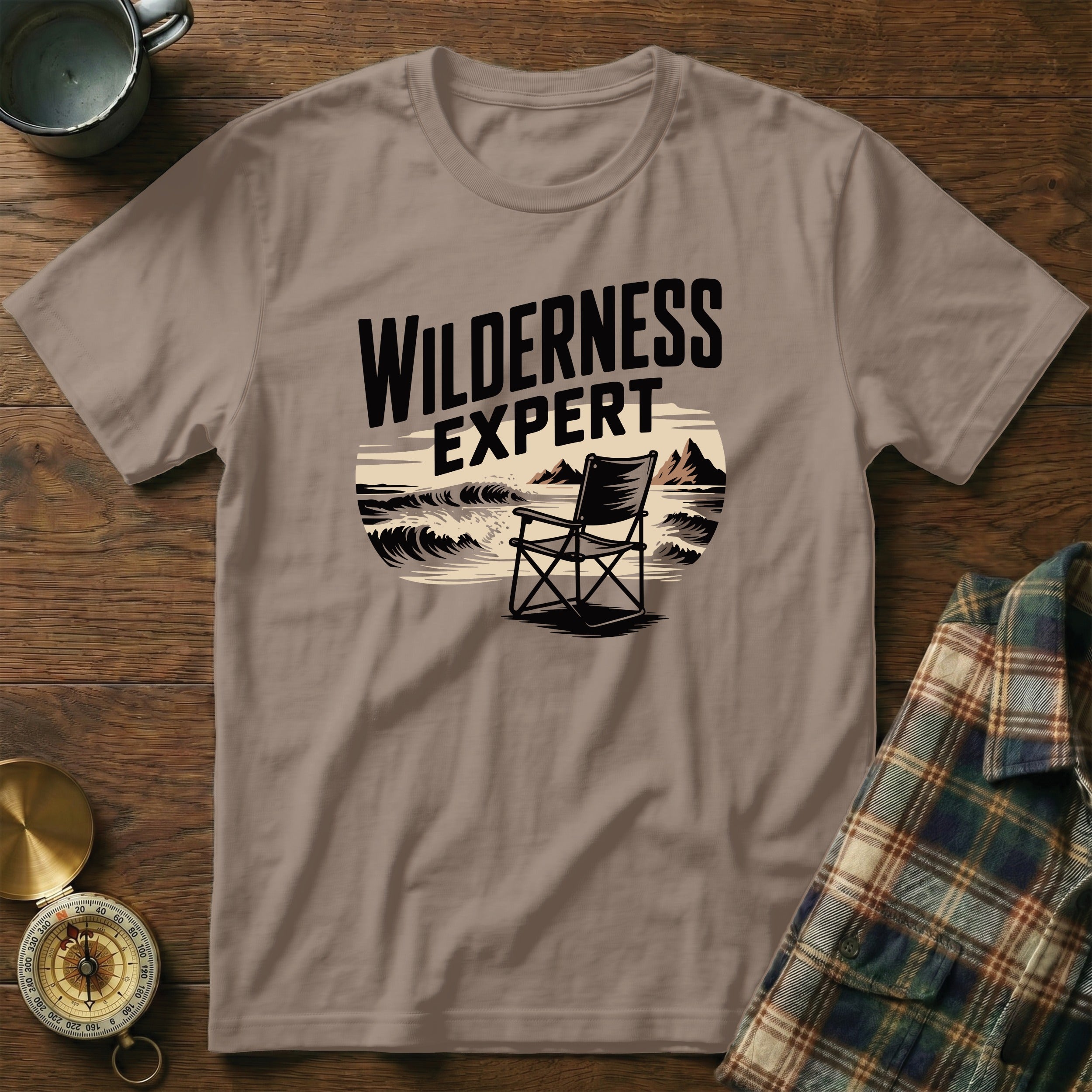 T-shirt with "WILDERNESS EXPERT" text and a beach chair scene.