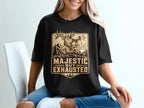 Black t-shirt with a deer blowing a horn and text "Majestic But Exhausted".