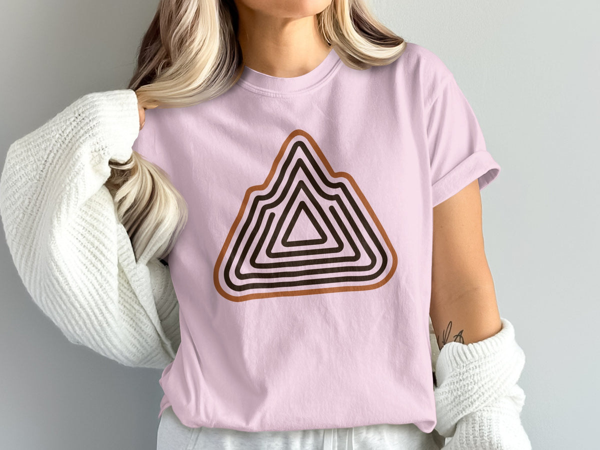 Pink t-shirt with layered mountain graphic in brown and black stripes.
