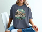T-shirt with graphic of seal on dock, lighthouse, and text "Professionally Unbothered".