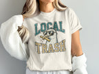 Cream t-shirt with a seagull wearing sunglasses and holding fries.