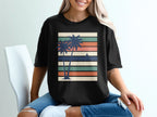 Black t-shirt with retro sunset and palm trees graphic design.