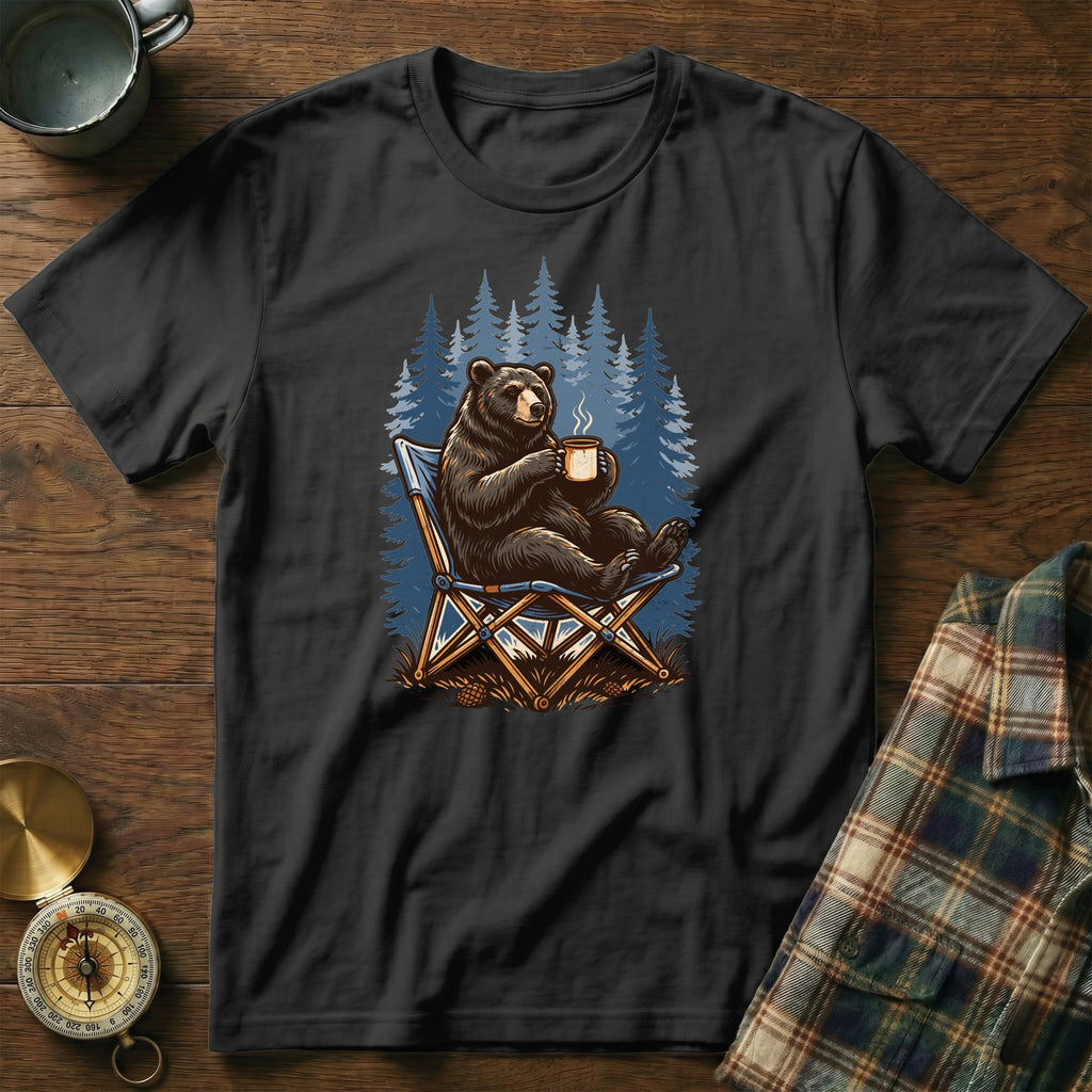 Black t-shirt with illustration of a bear sitting in a camping chair with a mug.