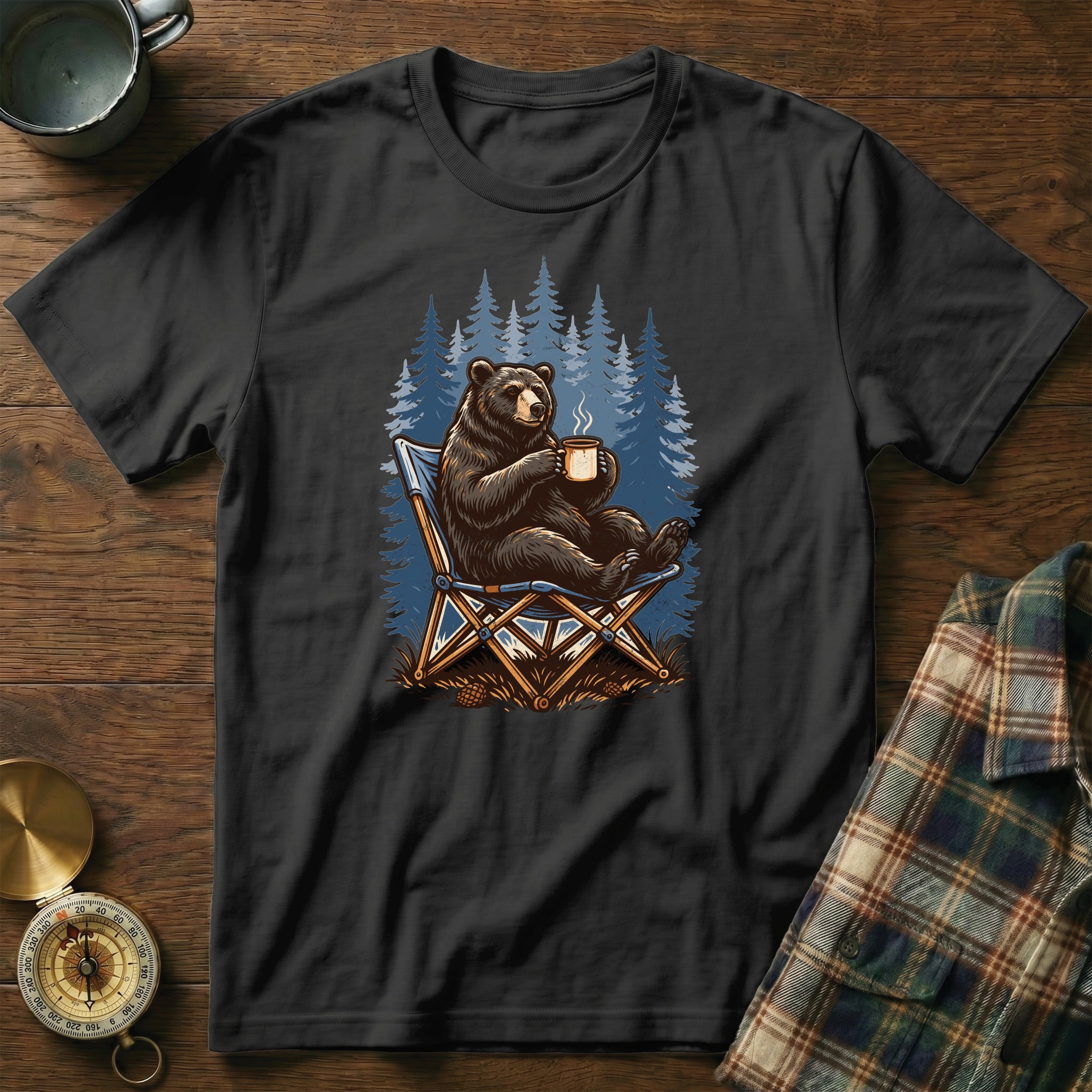 Black t-shirt with illustration of a bear sitting in a camping chair with a mug.