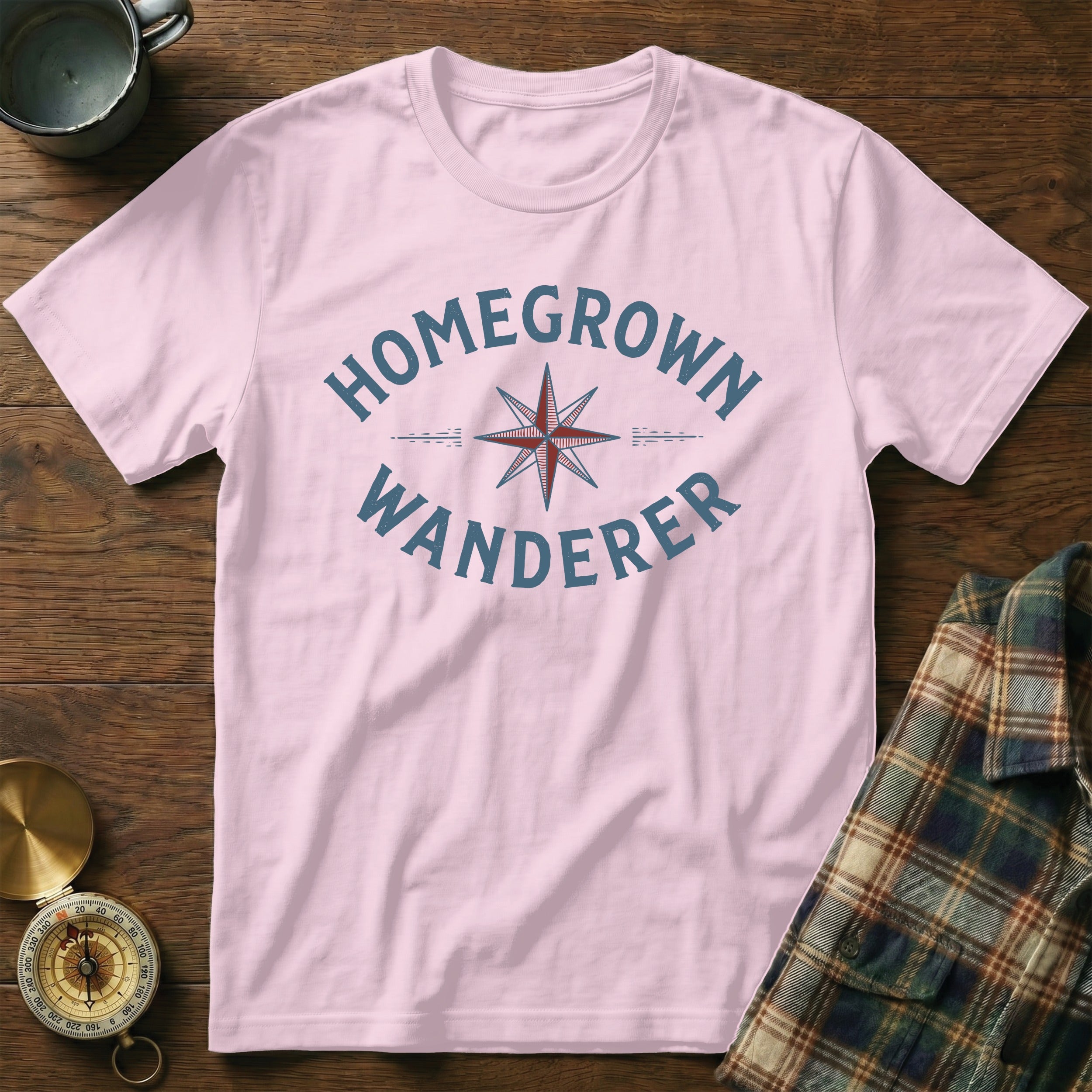 Light pink t-shirt with "HOMEGROWN WANDERER" text and compass graphic.