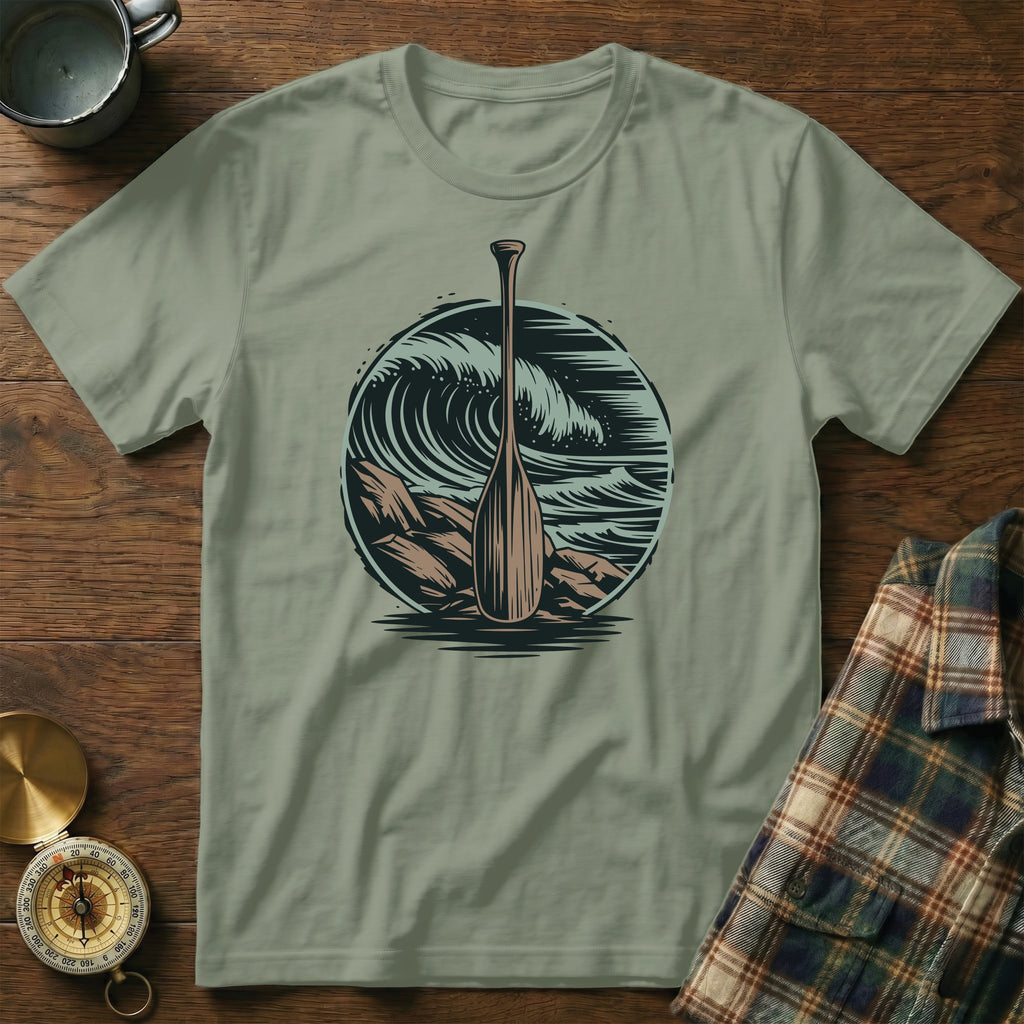 T-shirt featuring a wooden oar against a circular wave and rock design.