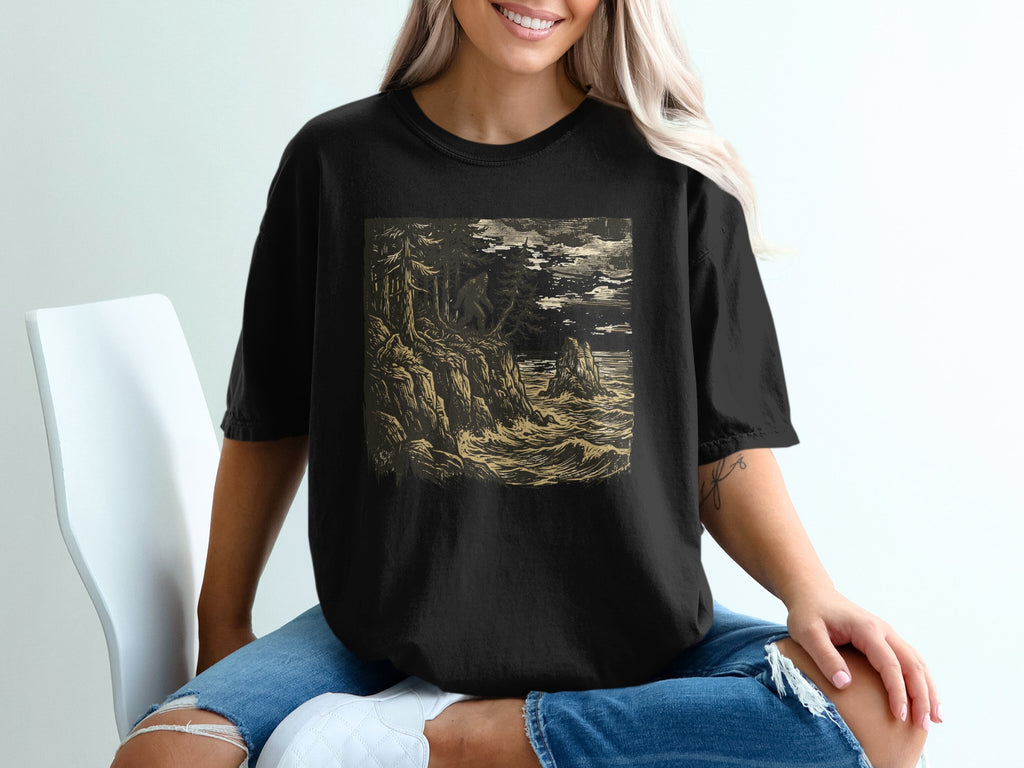 Black t-shirt with a dark, stormy seascape illustration.