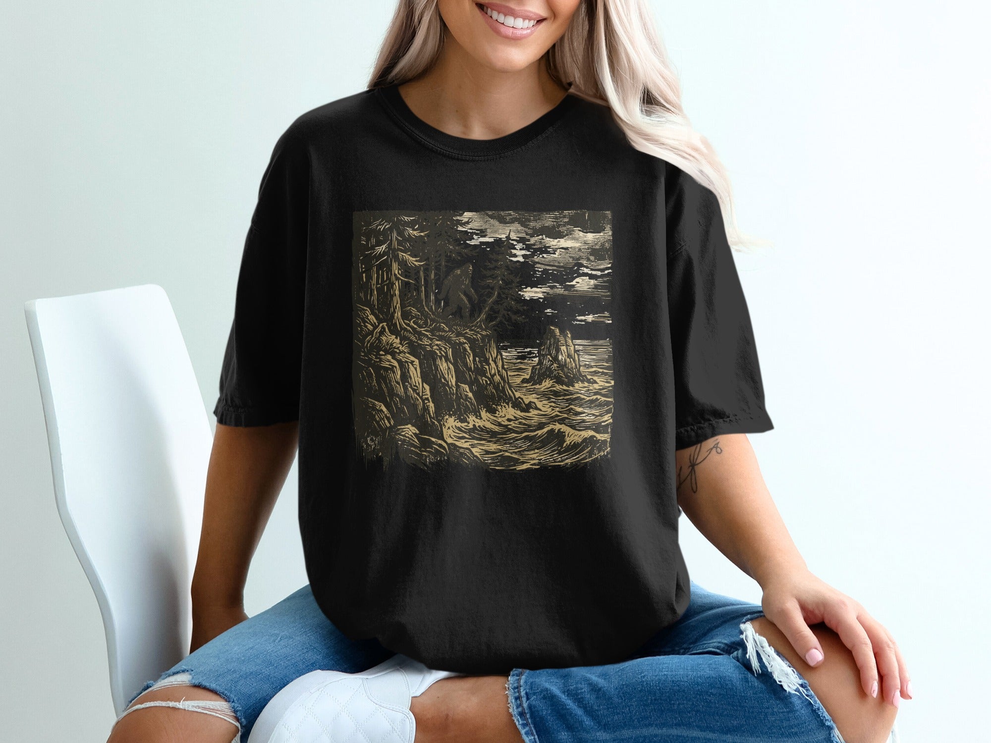 Black t-shirt with a dark, stormy seascape illustration.