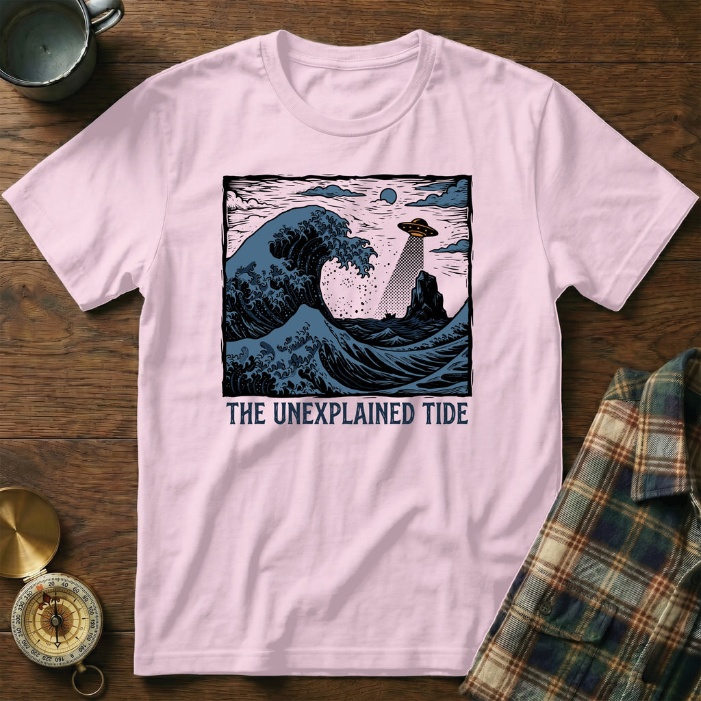 Pink t-shirt with "THE UNEXPLAINED TIDE" text and a UFO over a crashing wave.
