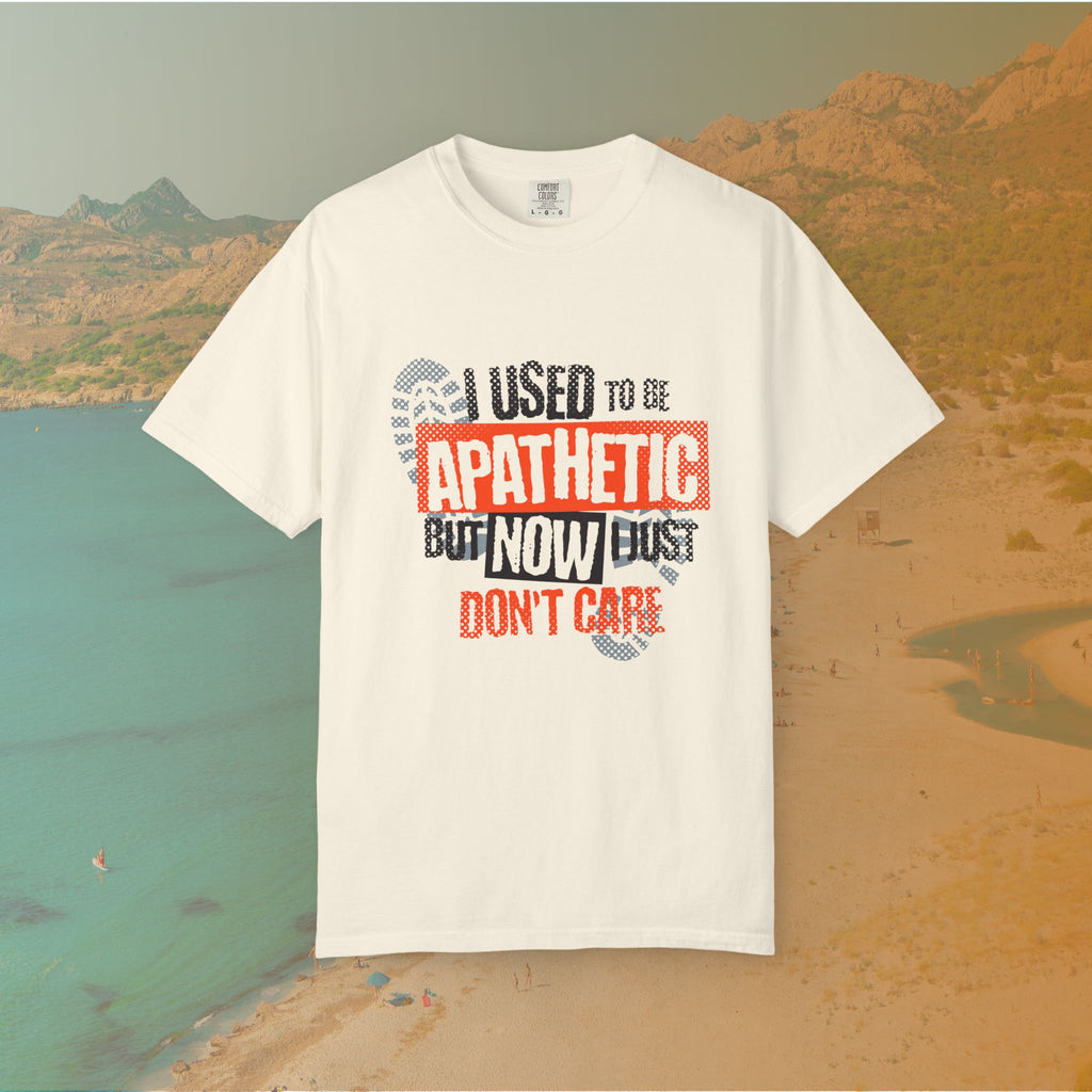 ivory Graphic T-shirt featuring the layered, distressed text: "I USED TO BE APATHETIC BUT NOW I JUST DON'T CARE," overlaid with halftone dot textures and boot print graphics.