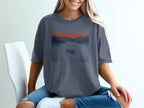 Canoe on a lake at sunset with mountains, graphic print on t-shirt.