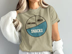 Tan t-shirt with pie chart reading "Complaining," "Miles," and "Snacks."