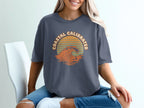 T-shirt with "Coastal Calibrated" text and a wave graphic.