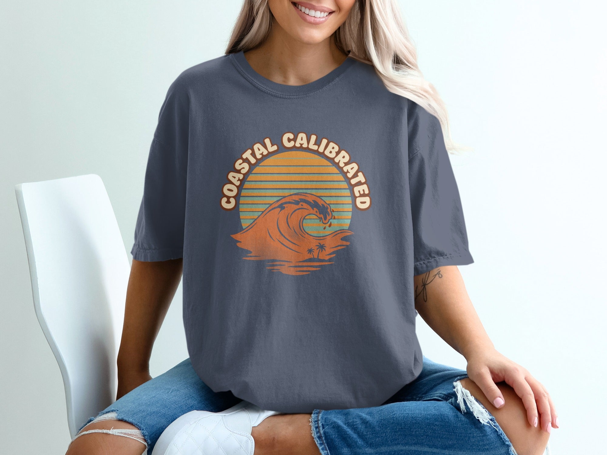 T-shirt with "Coastal Calibrated" text and a wave graphic.