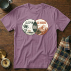 Purple t-shirt with a Venn diagram design: "Sleep In" with a beach scene and "Go Hiking" with mountains.
