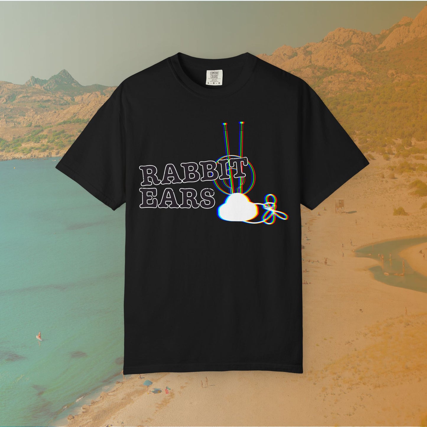Black t-shirt distressed EDM music festival text "RABBIT EARS" next to a graphic of a vintage TV antenna and cloud shape with a red, green, and blue (RGB) chromatic aberration/glitch effect, with an RGB shift design