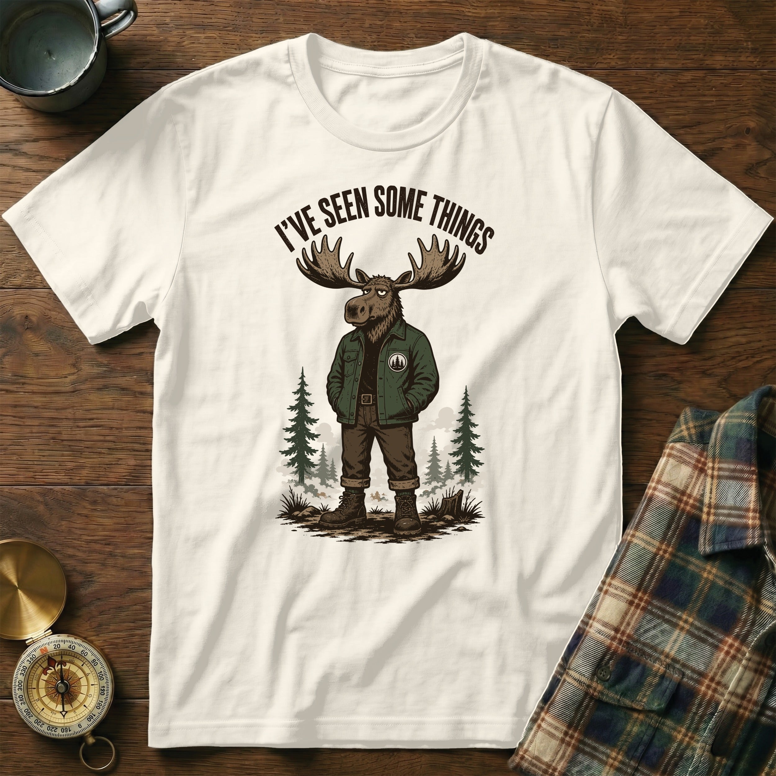 White t-shirt with a graphic of a moose wearing a jacket and text "I'VE SEEN SOME THINGS".