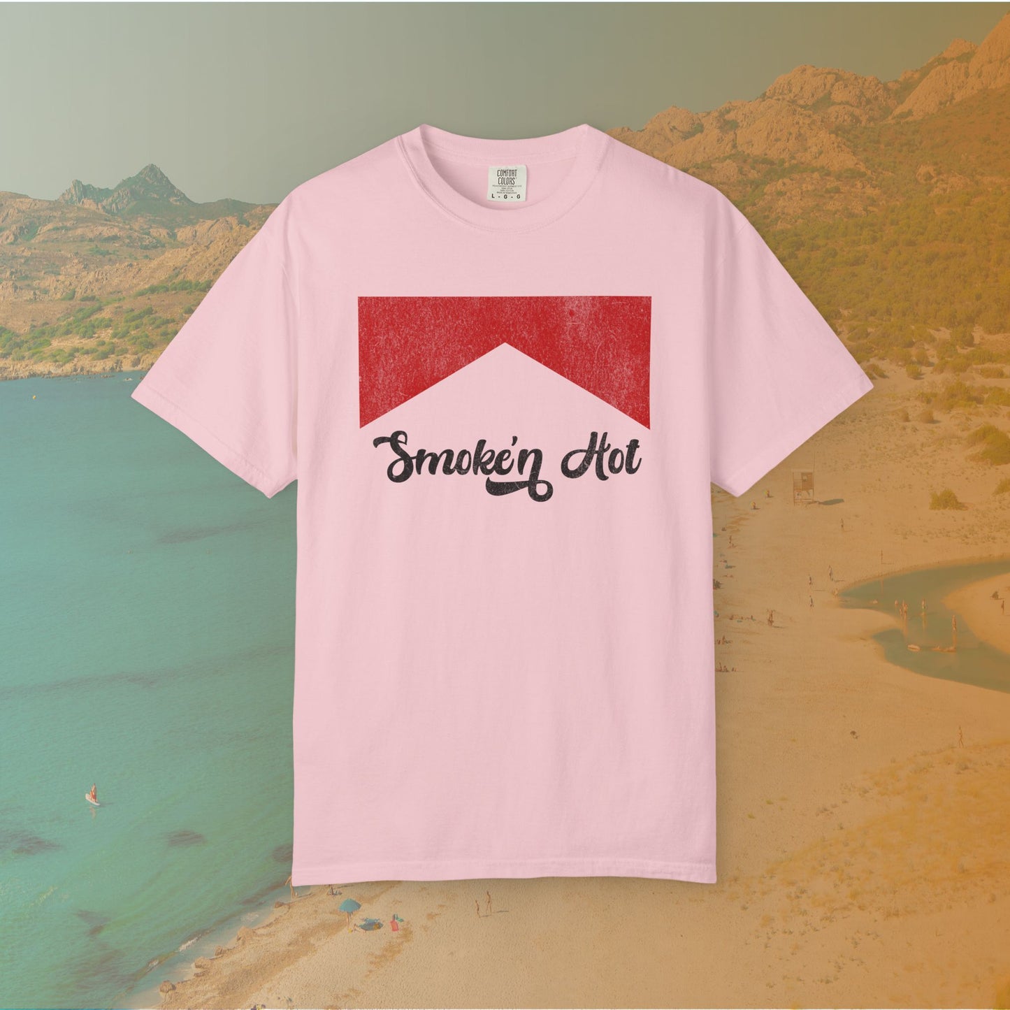 pink Graphic T-shirt featuring a distressed red chevron shape with the black script text "Smokin' Hot" centered below it, in a vintage style.
