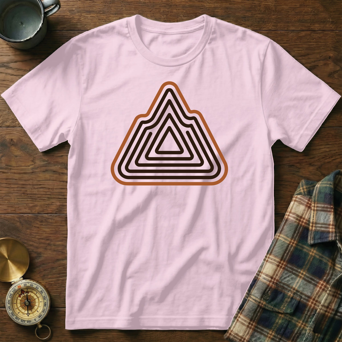 Pink t-shirt with a geometric mountain outline graphic in brown and black.