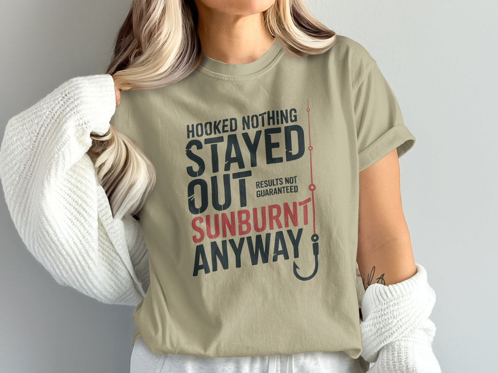 Tan t-shirt with "Hooked Nothing Stayed Sunburnt Results Not Guaranteed" text and fishing hook.