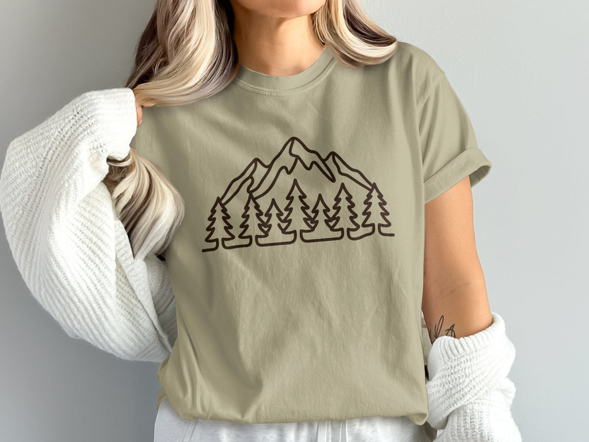 T-shirt with brown line art of mountains and pine trees across chest.