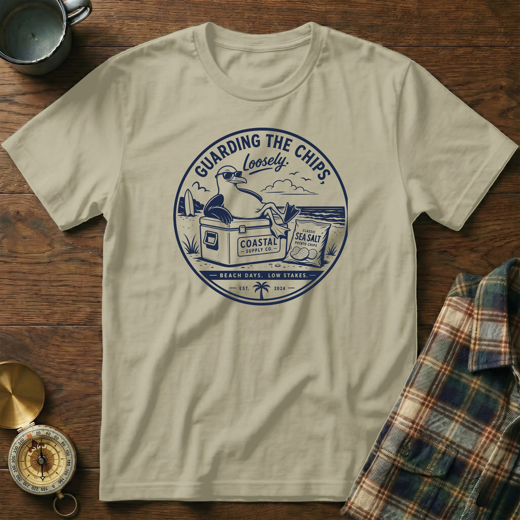 T-shirt with graphic of a seagull guarding chips with text "Guarding the Chips Loosely".