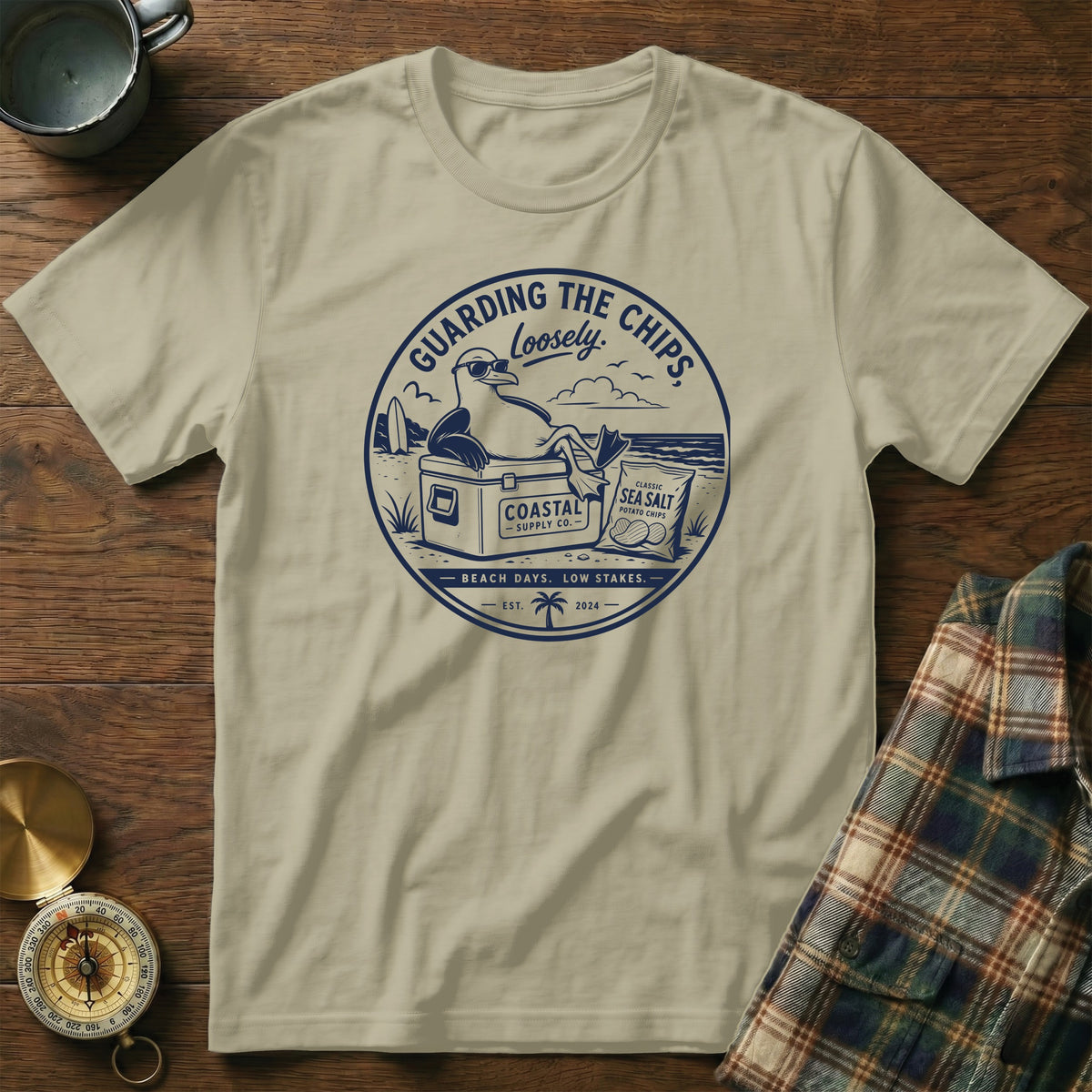 T-shirt with graphic of a seagull guarding chips with text "Guarding the Chips Loosely".