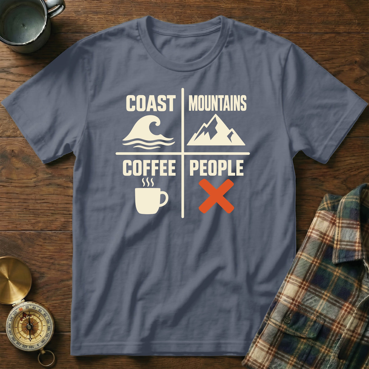 Slate blue t-shirt with "Coast Mountains, Coffee People" graphic and icons.