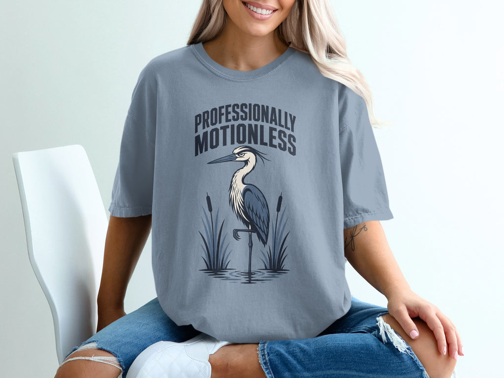 T-shirt with "Professionally Motionless" text and a heron standing in water.