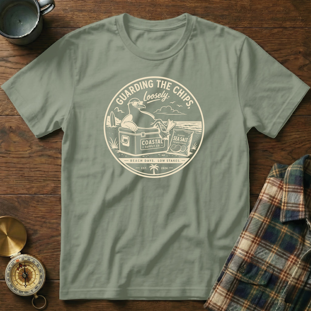 T-shirt with a circular graphic of a seagull relaxing on a cooler with potato chips.