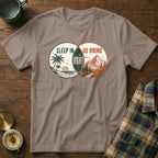 T-shirt with a graphic depicting a beach scene and mountains, reading "Sleep In Regret Go Hiking".