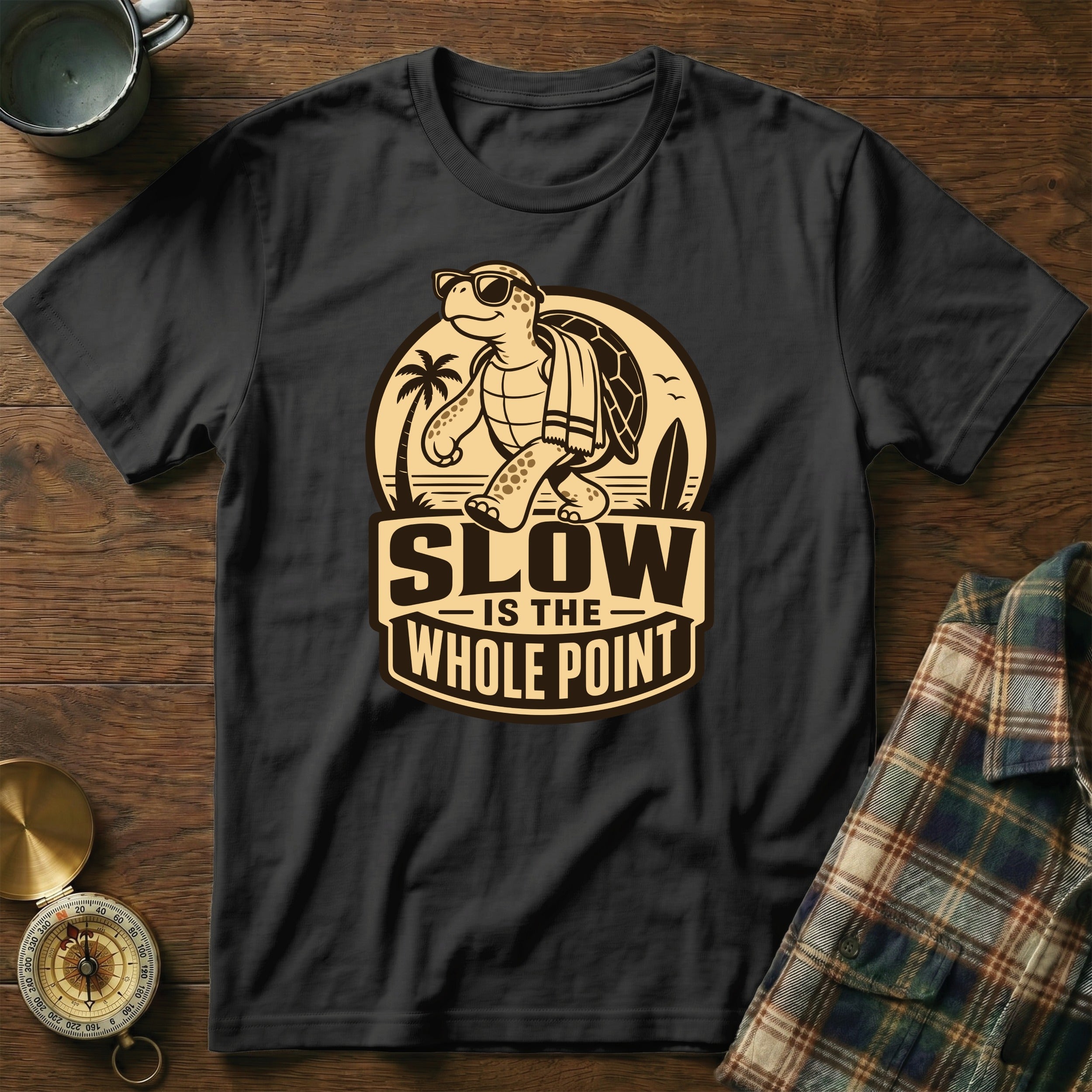 Black t-shirt with graphic: walking turtle, surf board, palm tree, text "SLOW IS THE WHOLE POINT".