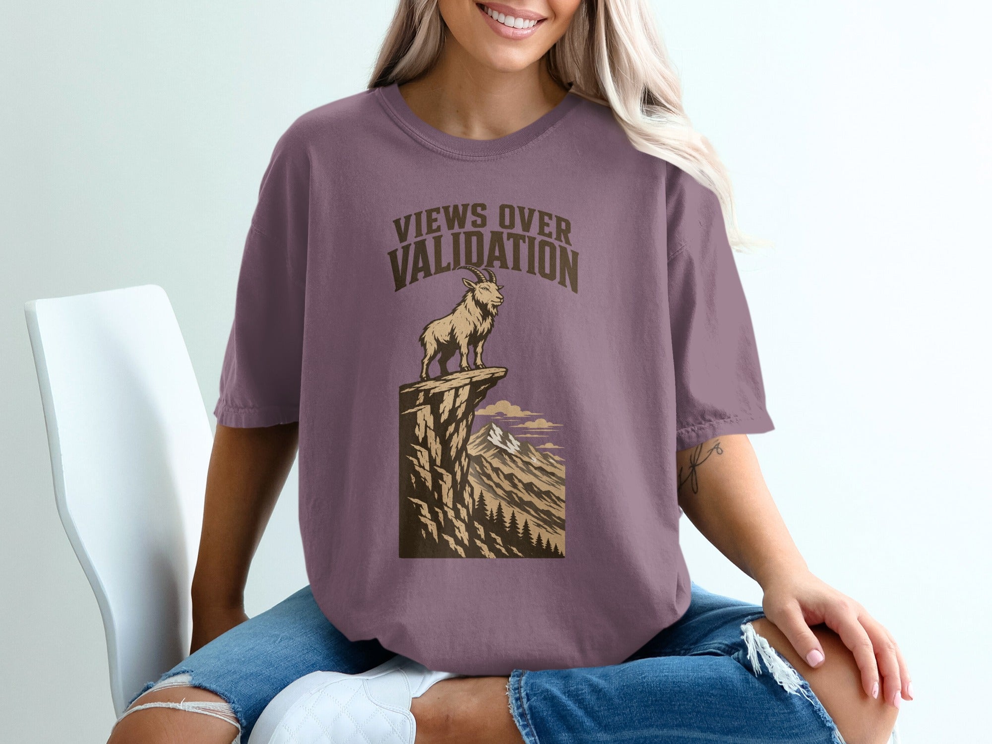 T-shirt with "Views Over Validation" text above a goat on a cliff.