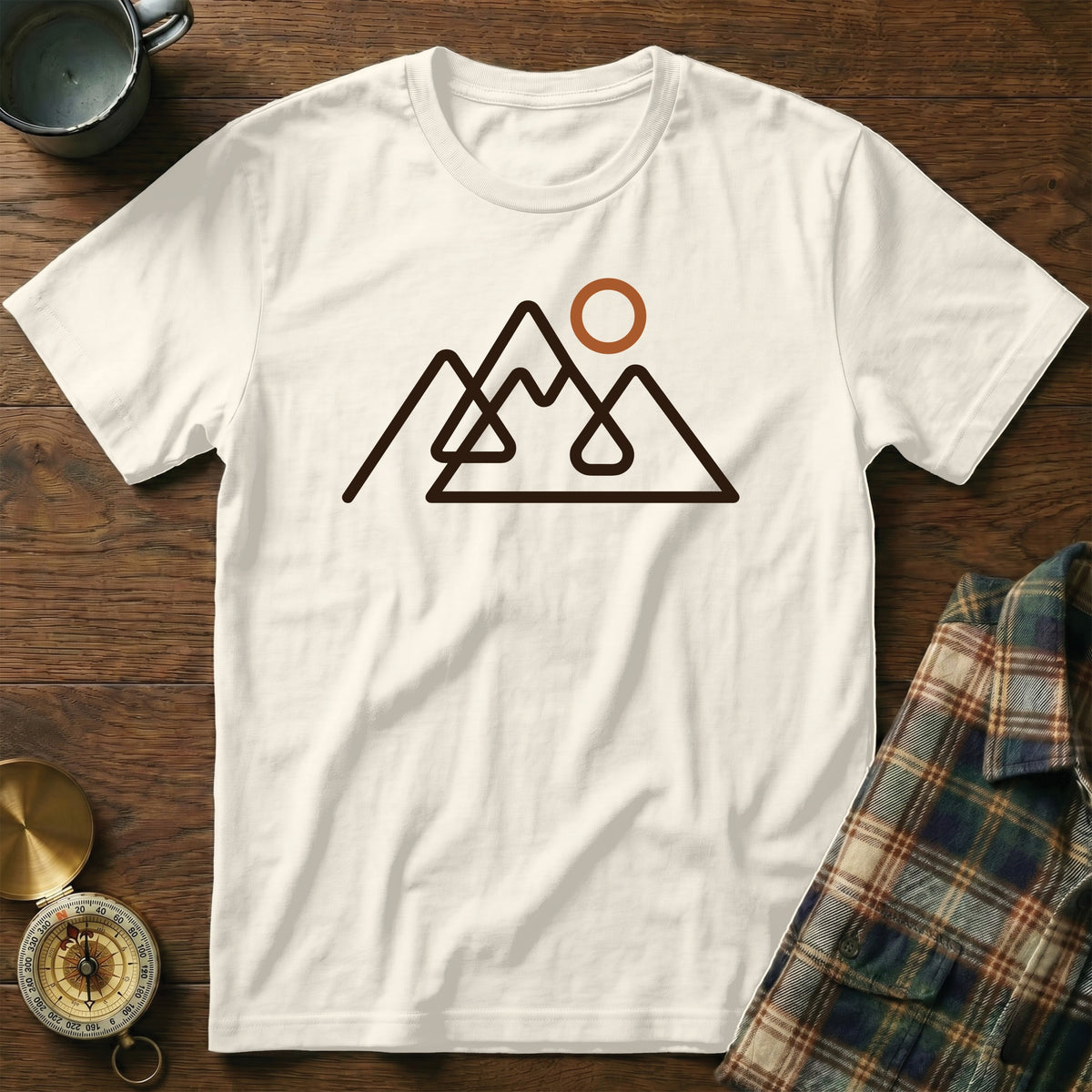 Off-white t-shirt with a minimalist mountain and sun graphic in brown.