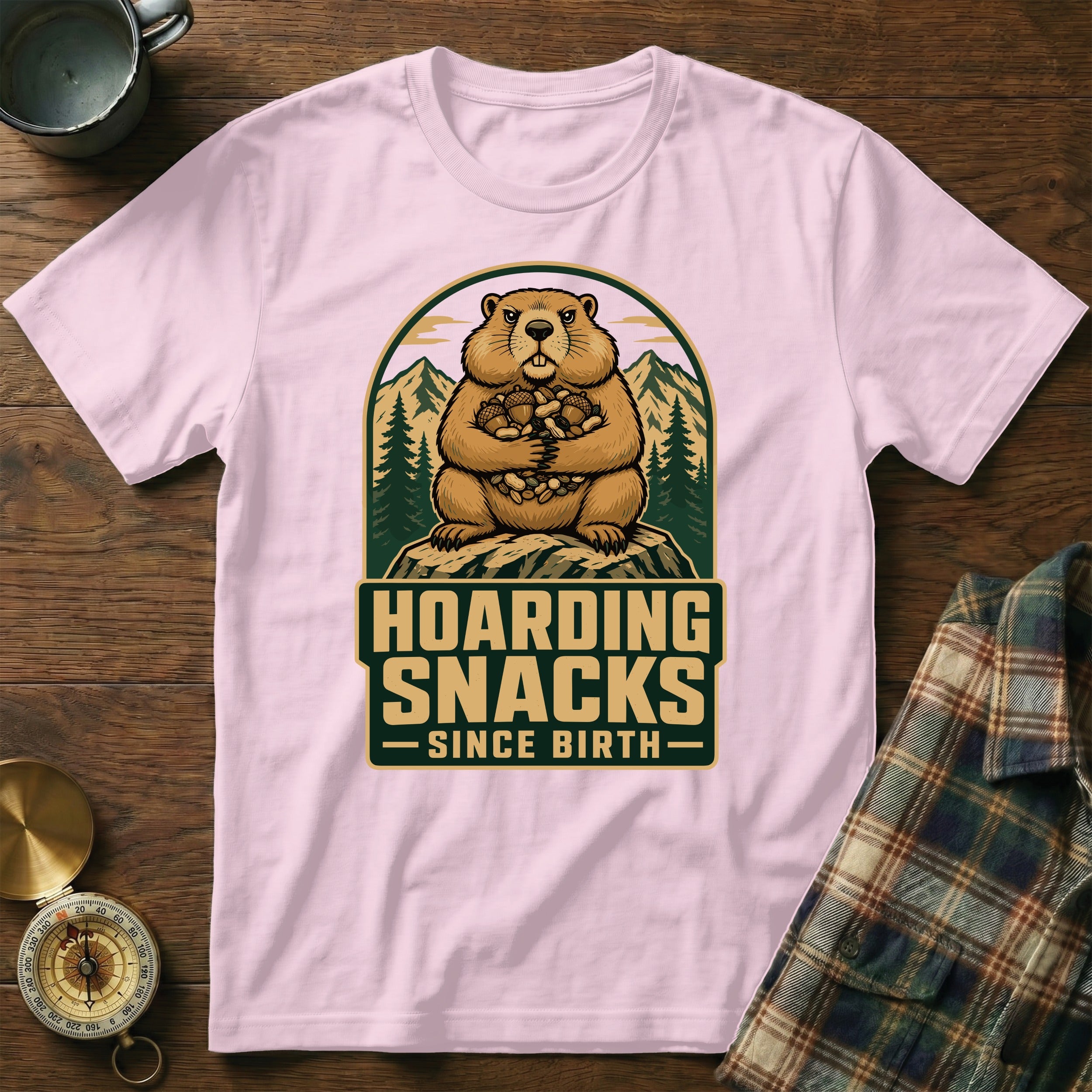 Groundhog on a rock holding nuts with "Hoarding Snacks Since Birth" text.