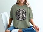 T-shirt graphic of a raccoon taking a selfie with text "Not a photobomb. I'm the whole shot."