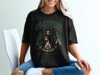 Black t-shirt with bear graphic, campfire, tent, trees, and text "GO OUTSIDE GREAT VIEW. UNCLEAR EXIT."