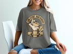 T-shirt graphic of a pelican with sunglasses and a fish, with text "LOW EFFORT, HIGH REWARD".