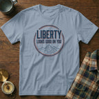Light blue t-shirt with "LIBERTY LOOKS GOOD ON YOU" graphic.