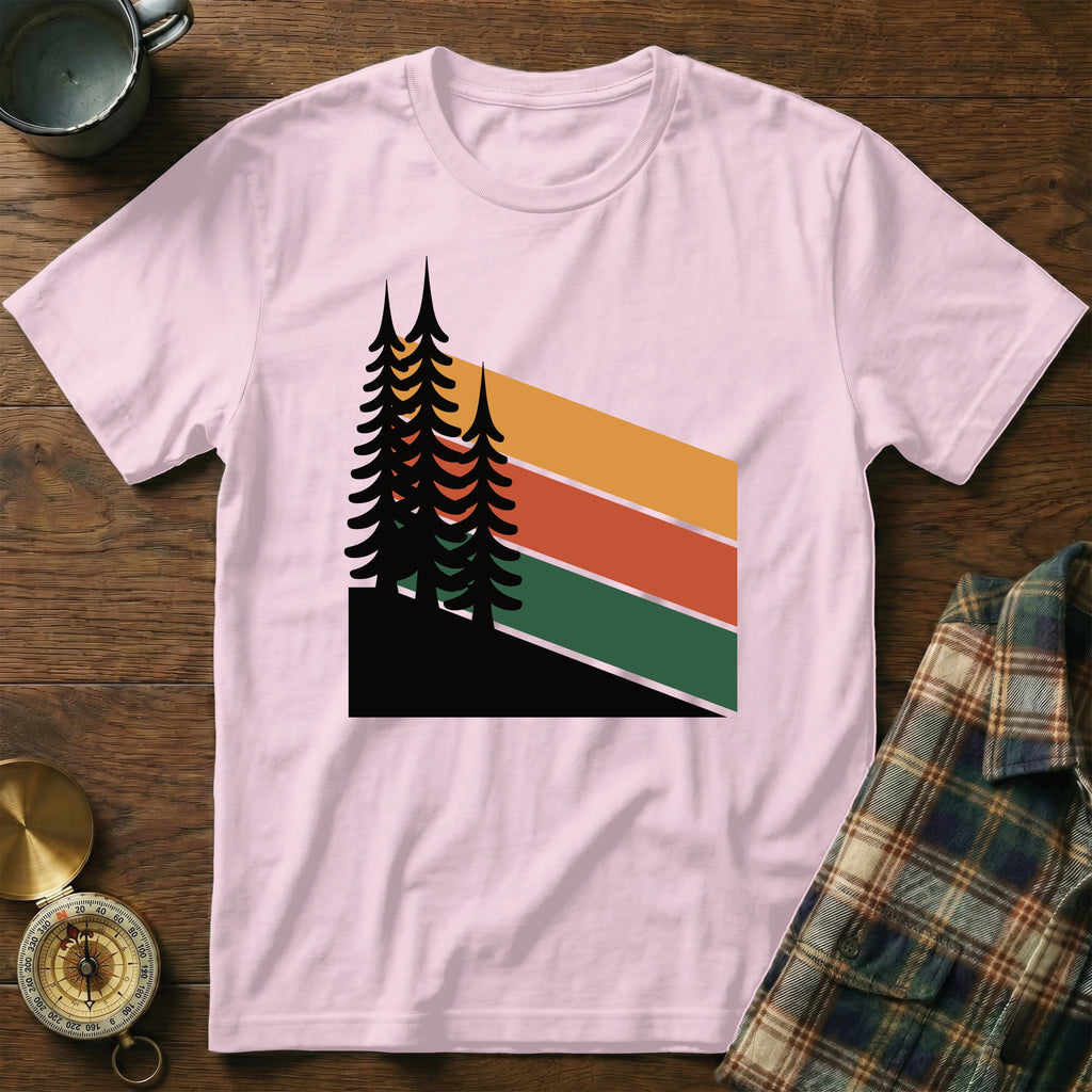 Pink t-shirt with a graphic of dark pine trees and colorful stripes.
