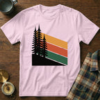 Pink t-shirt with a graphic of dark pine trees and colorful stripes.