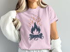 Pink t-shirt with dark blue and orange campfire graphic.