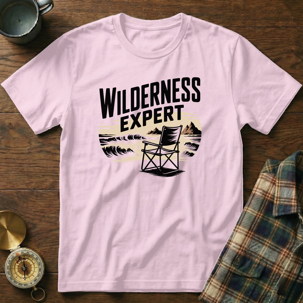 Pink t-shirt with "WILDERNESS EXPERT" text and a camping chair design.
