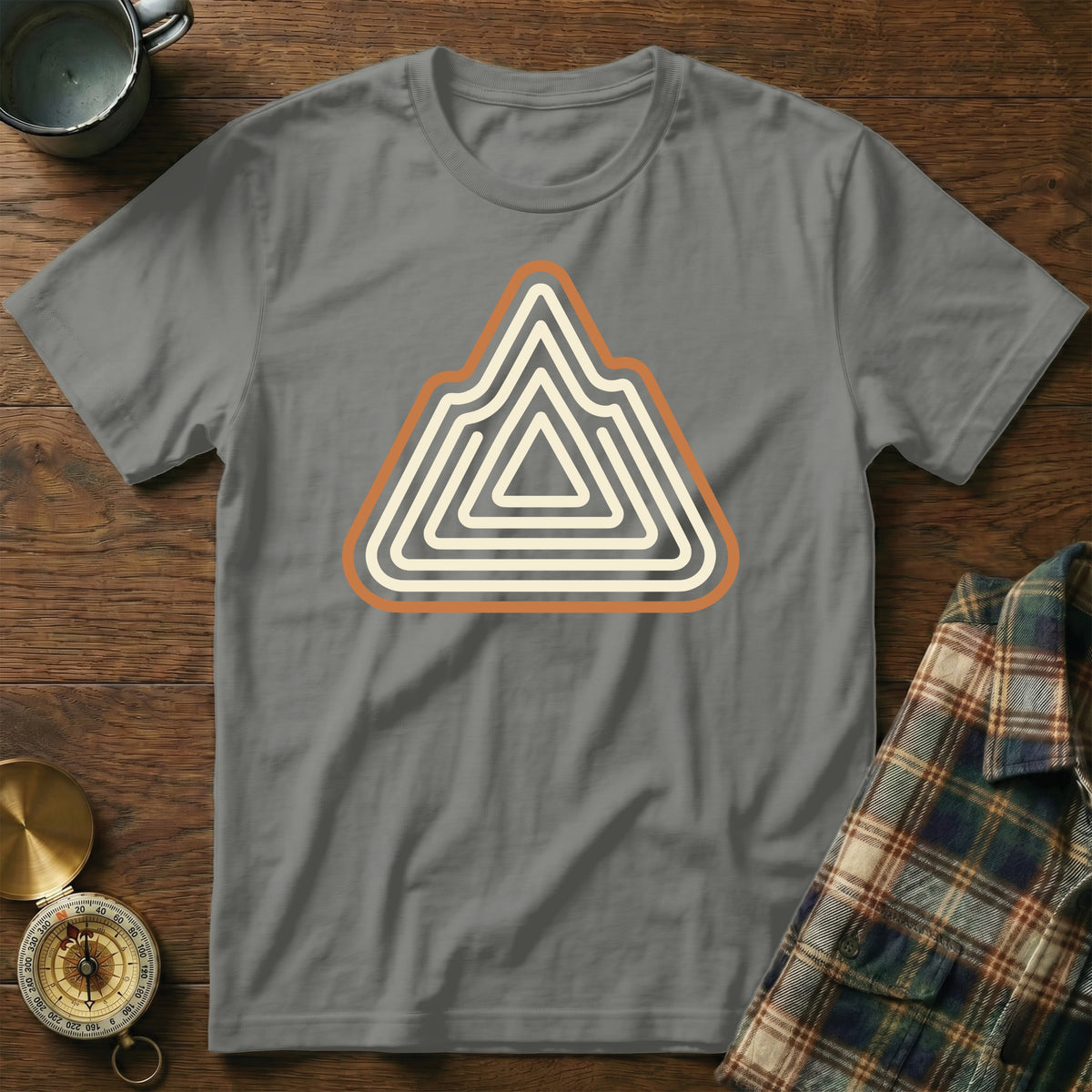 Grey t-shirt with a triangular mountain logo in cream and orange stripes.