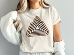 Off-white t-shirt with a geometric mountain range graphic in brown and black.