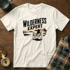 Cream t-shirt with "WILDERNESS EXPERT" graphic featuring a chair on a beach.