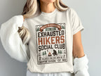 T-shirt with "Exhausted Hikers Social Club" text and campfire graphic.